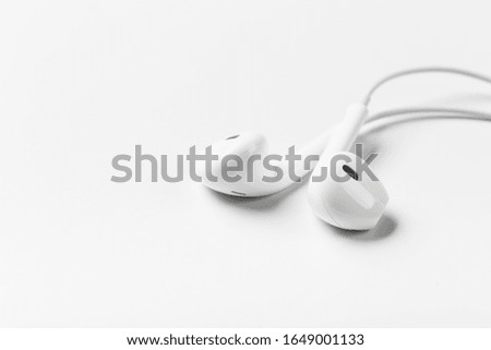White modern headphones with a headset on a light gray background. concept of digital music