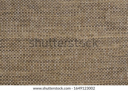 Background of beige fabric with large threads