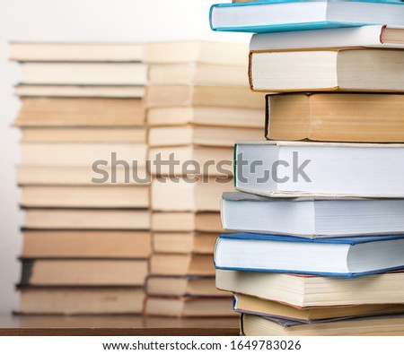 Different books collection in pile on the desk