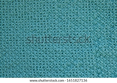 Handmade knitted woolen fabric in blue.