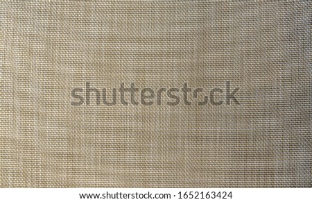 Burlap sackcloth textured background. Beige rough cloth, natural organic textile material. Woven fabric crisscross string threads, sack grid pattern. Grunge vintage empty flat layout texture.