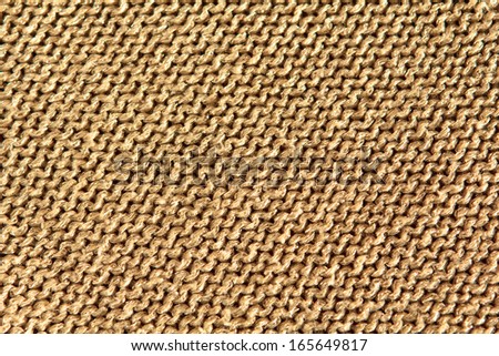 Sparkly gold background fabric texture knitted in reverse stocking stitch