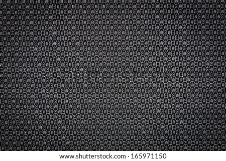 Black plastic surface with cells pattern texture background.