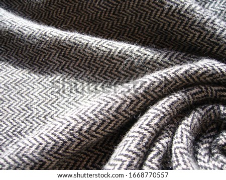 The texture of the fabric. Gray knit fabric with geometric patterns of wool and cotton.