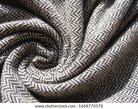 The texture of the fabric. Gray knit fabric with geometric patterns of wool and cotton.