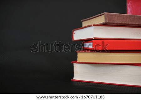 Red books on a black background