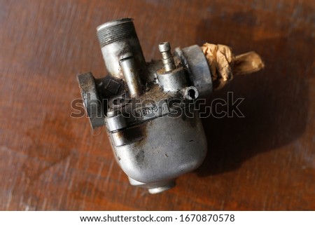 A dirty aluminum carburetor for a motorcycle must be thoroughly washed in gasoline and then brushed and blow off the valves with compressed air.