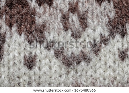 Photo of a piece of white and brown woollen cloth taken from close up. 