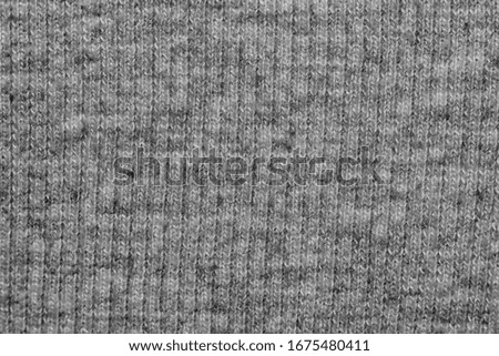Photo of a piece of gray woollen cloth taken from close up. 