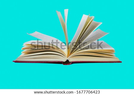 open book on a turquoise background