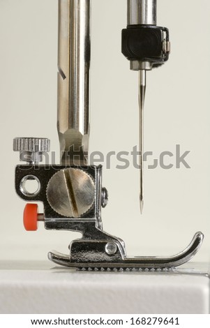 Close up of sewing machine head and needle from side view