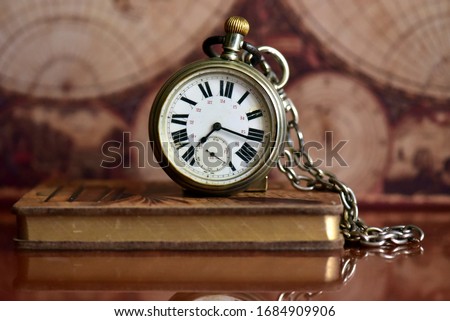 Old pocket watch on a table