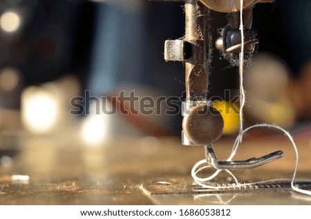 Old sewing machine .Focus sewing needle background blure