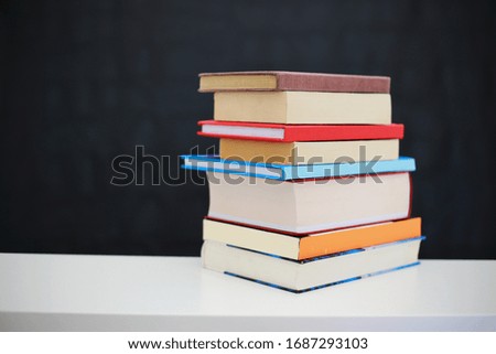 A bunch of books on a black background