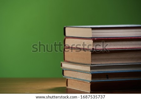 Stack of books isolated on green background
