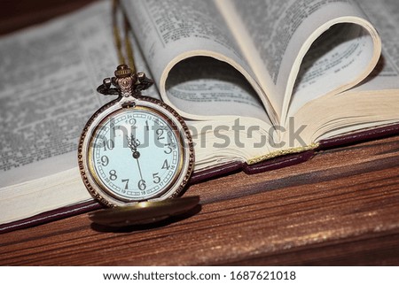 pocket watch with book background