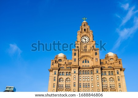 The Liver Building on a sunny day, blue sky. Liverpool, Merseyside, UK - space on the left for copy text.