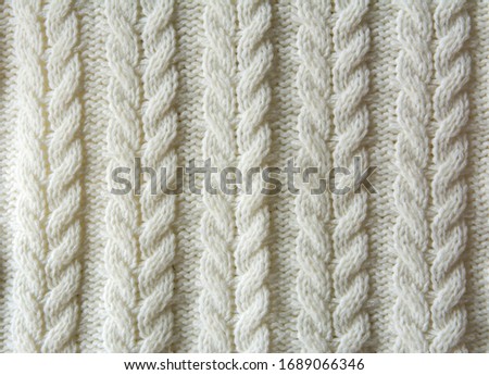 White Knitted wool texture of a fabric with cable knit pattern
