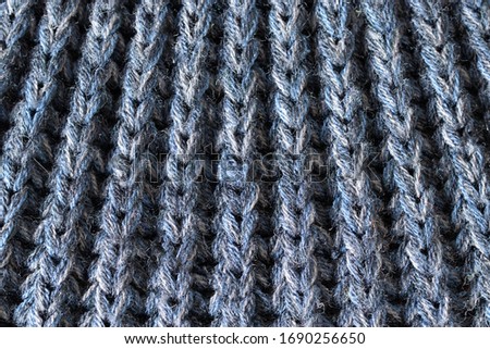 Crochet pattern, a close-up of a simple blue knitting pattern for background