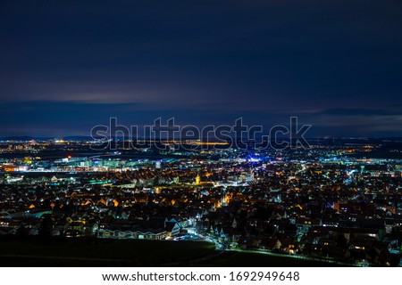 Germany, Aerial view above houses, skyline and streets of fellbach city near stuttgart, illuminated cityscape by night