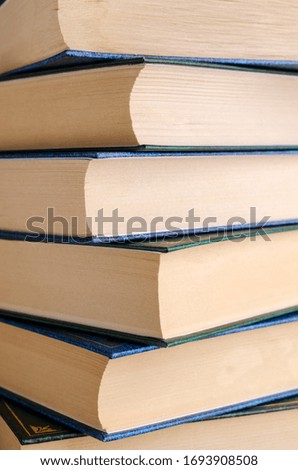 Closeup background of a stack of books. Design concept. Selective focus.