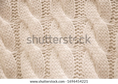 The texture of a knitted cozy sweater. Knitting, home accessories.