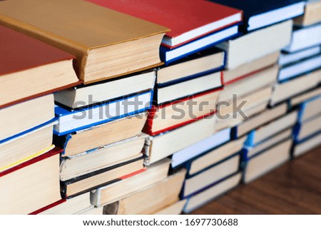 stack of old book on wooden table, education concept background, many books piles with copy space for text