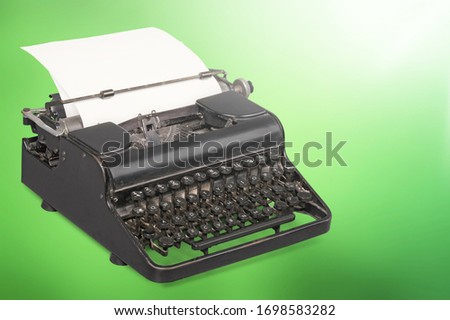 Retro classic typewriter with a sheet of paper on the desk