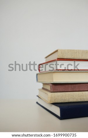 Book stack in the library room and blurred bookshelf for business and education background