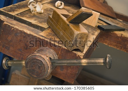 Old wooden vise and tool in a workshop. All wooden