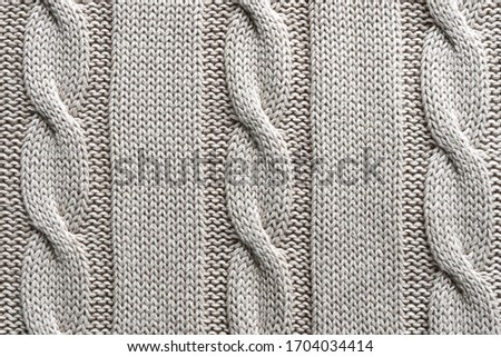 Texture gray knitted fabric with a pattern.