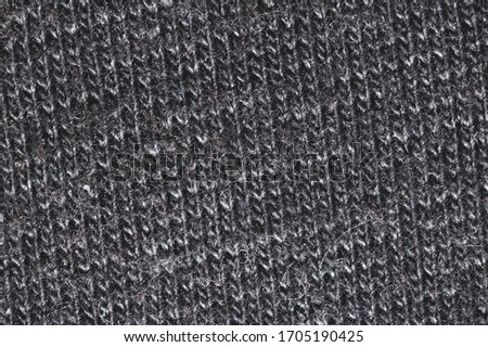 Black fabric texture. knitted textile close up. woven background