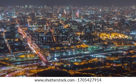 Aerial view of Lima skyline night view from San Cristobal hill. Traffic on bridges and Rimac river. Landscape of slum urban area and historic buildings with skyscrapers in South America. Peru