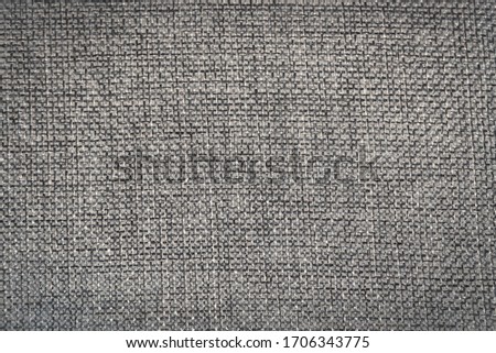 Abstract background of roughly woven grey fabric for design