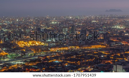 Aerial view of Lima skyline day to night transition timelapse from San Cristobal hill. Traffic on bridges and Rimac river. Landscape of slum urban area and historic buildings with skyscrapers in South