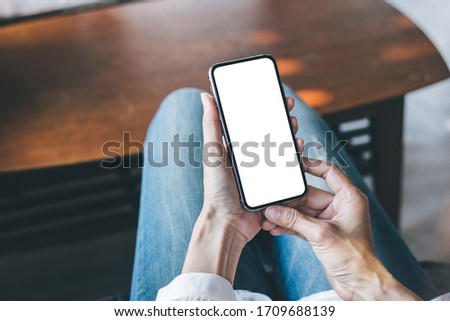cell phone Mockup image blank white screen.woman hand holding texting using mobile on desk at coffee shop.background empty space for advertise text.people contact marketing business,technology 