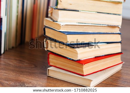 stack of old book on wooden table, education concept background, many books piles with copy space for text