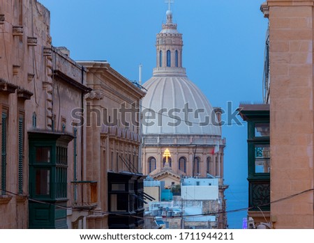 The Basilica of Our Lady and bell tower in the historical part of Valletta at sunset. Malta.