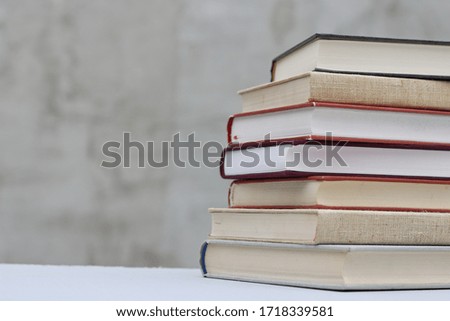 Stack of books on gray background