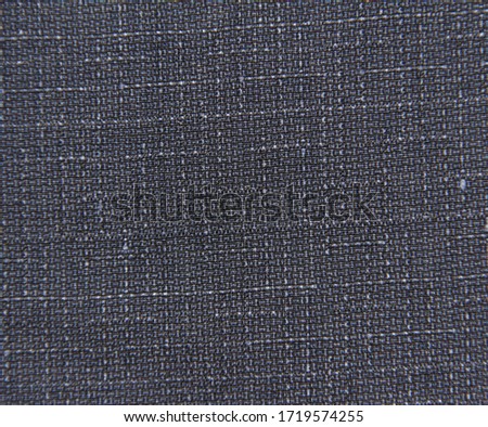 Dark blue fabric background with spots. The texture of the fabric in the perpendicular lines.