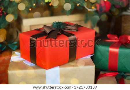 christmas tree with presents,red and green box with brown ribbons.
