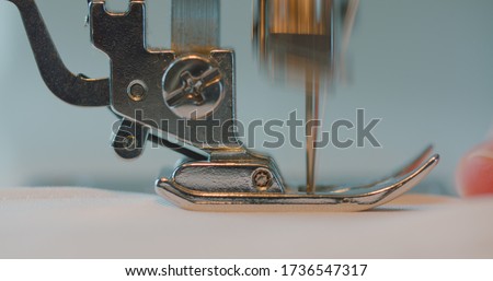 Close-up of a sewing machine foot, sew a seam.