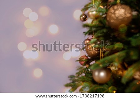 Gold Christmas balls on blurred background. Christmas card.