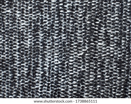 
Black and white, hairy fabric with stripes and visible texture. background or texture, closeup.