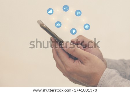Man with a hand holding a smartphone on social media.Digital network  concept.