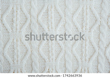 White knitted woolen background with space for text.