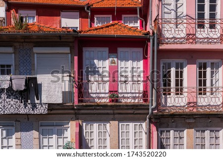 Traditional Colorful Houses with Small Balconies and Clothes Hanging Dry at Porto, Portugal