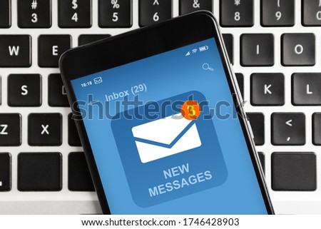 Modern Smartphone With New Email Message Notification On Screen Flat Lying On Laptop Keyboard, To View