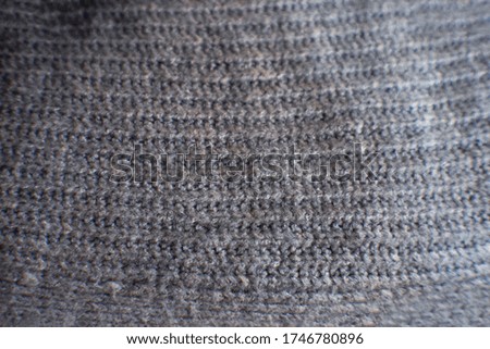 Texture gray knitted fabric with a pattern.