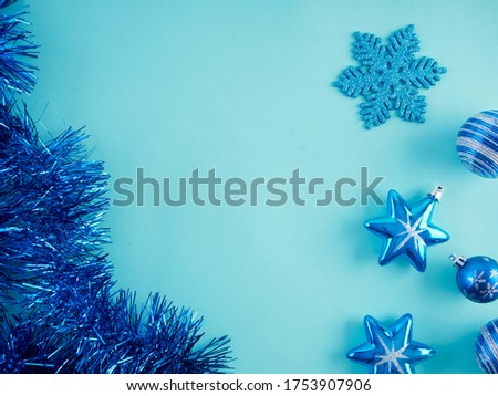 Close-up of christmas decorations against light blue background. Space for text.